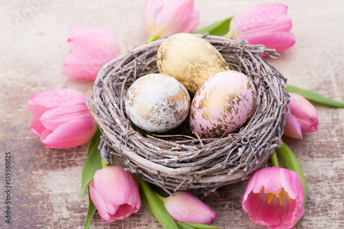 Easter eggs in the nest. Spring flowers tulips.