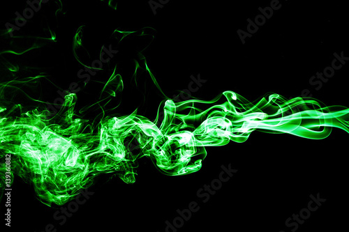 Green colored smoke on a black background.