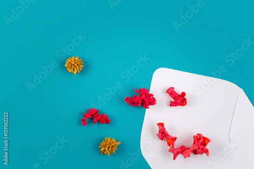 White envelop and colorful dried flowers, plants on blue background. Top view, flat lay © vejaa