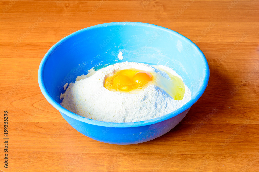 Eggs in flour. Preparation for baking. Detail of the egg yolk. Raw materials for the production of dough. Eggs in flour. Preparation for baking. Detail of the egg yolk. Raw materials for the production of dough.