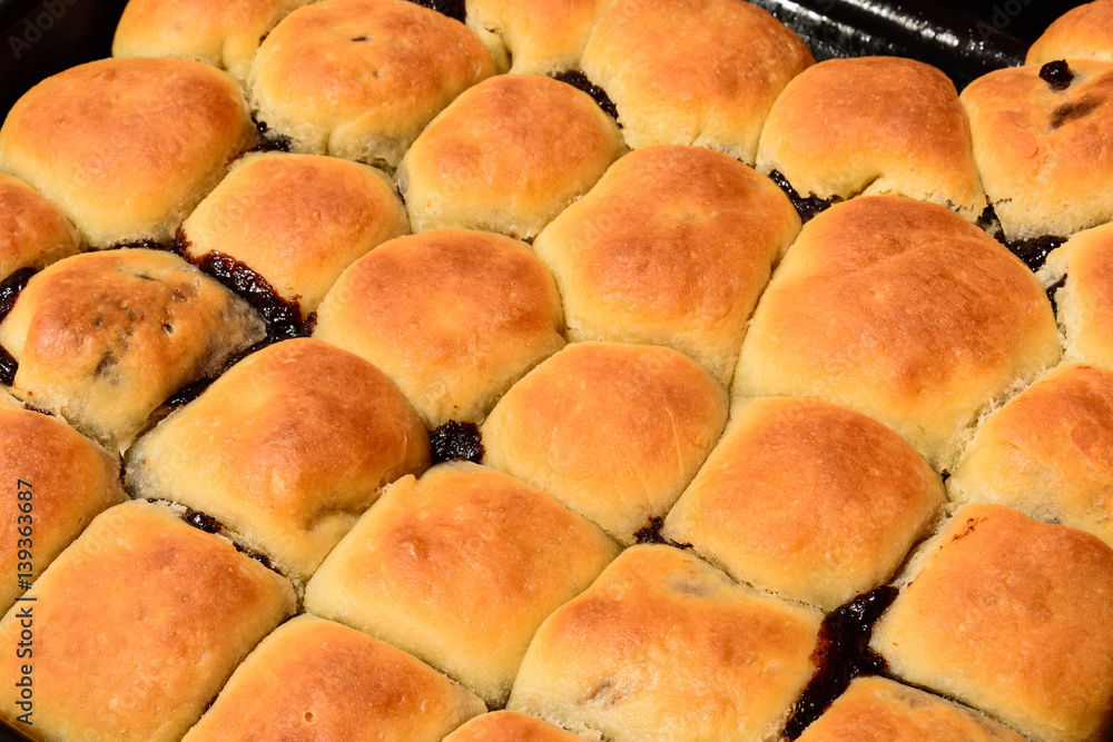 Czech baked buns with jam and sugar. Baking cakes. Traditional Czech recipe for buns. Festive delicacies. Buns on a baking pan.
