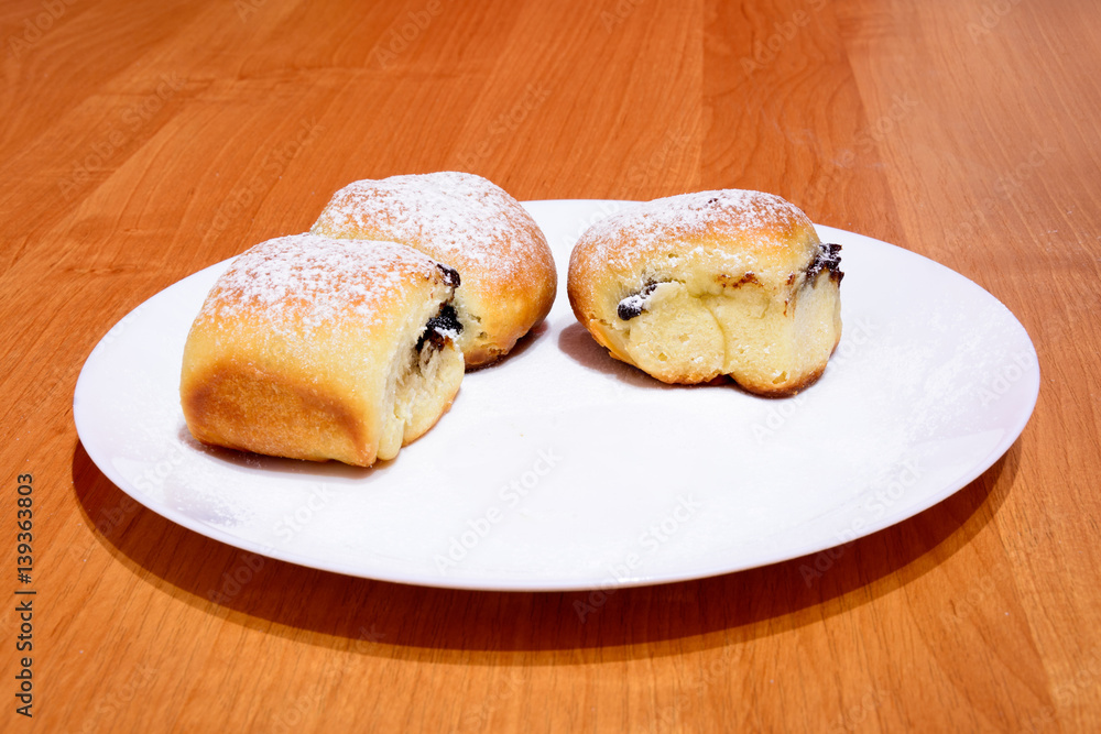 Czech baked buns with jam and sugar. Baking cakes. Traditional Czech recipe for buns. Festive delicacies. Buns on a plate. Czech baked buns with jam and sugar. Baking cakes. Traditional Czech recipe for buns. Festive delicacies. Buns on a plate.