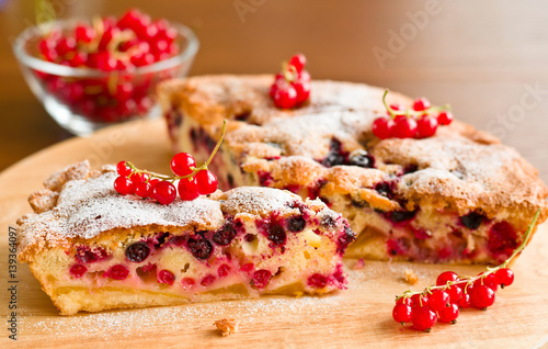 Piece of berry pie and red currants