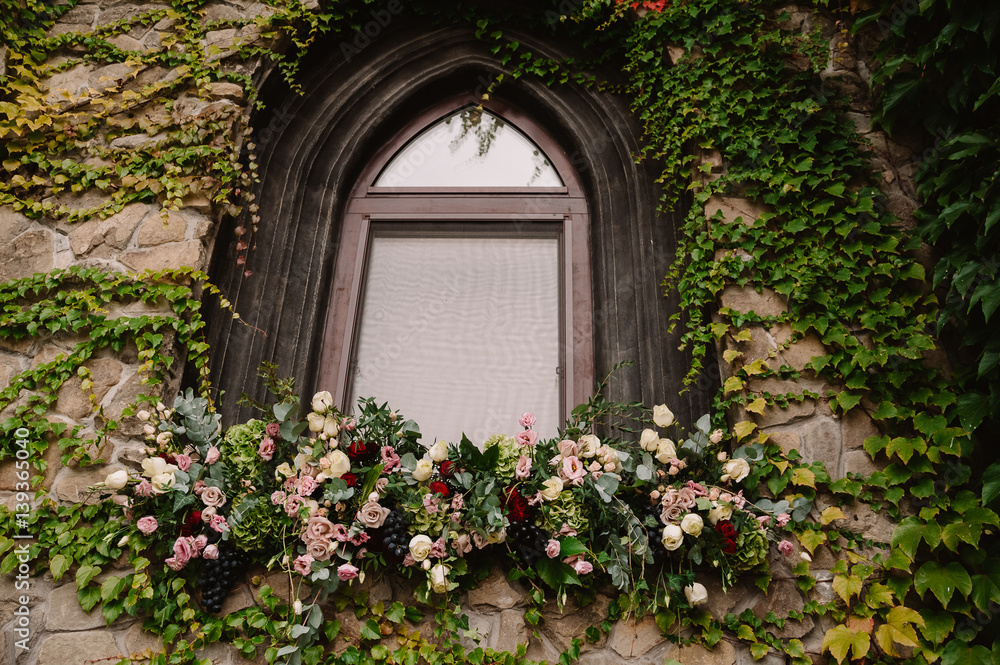 Old stone wall with a wedding decorated window