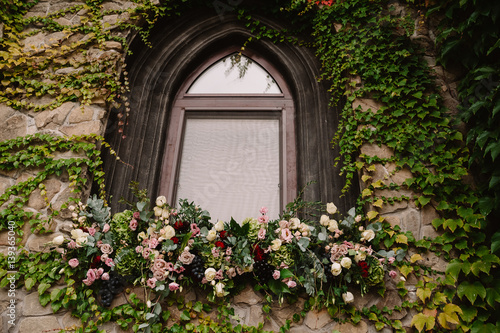 Old stone wall with a wedding decorated window photo