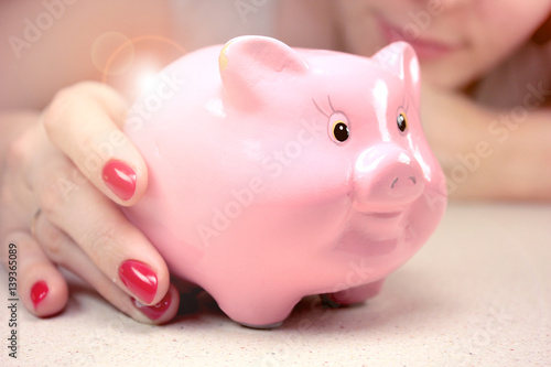 Girl playing with piggy bank