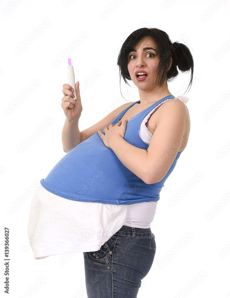 young pregnant woman scared in shock checking pink positive result on pregnancy test young pregnant woman scared in shock checking pink positive result on pregnancy test