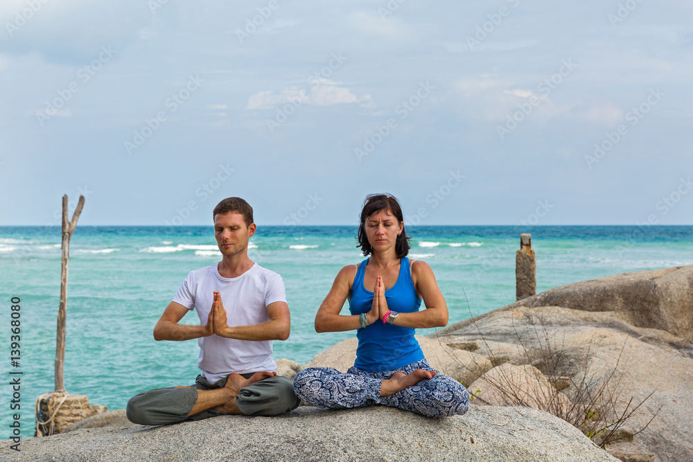 Yoga for two on the sea