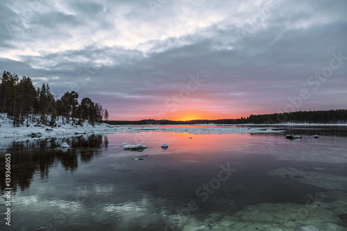 Bright winter sunset on the White sea, the Bay near the village Nilmoguba, Karelia, Russia