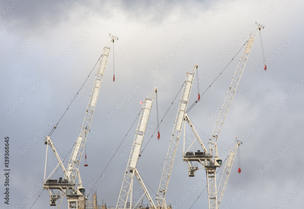 cranes for building construction with clouds in background