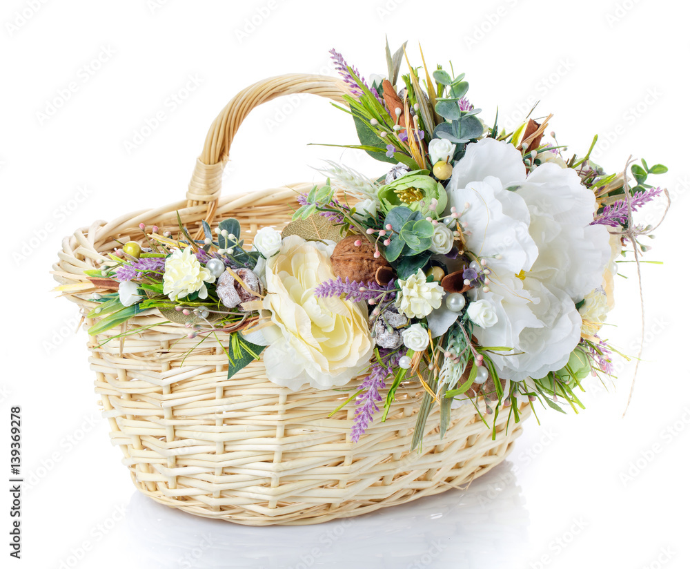 Basket decorated with flowers on white background