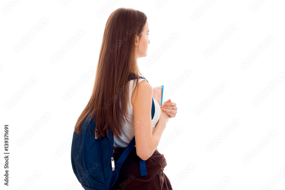 beautiful young girl in white shirt and with a portfolio turned his back to the camera beautiful young girl in white shirt and with a portfolio turned his back to the camera