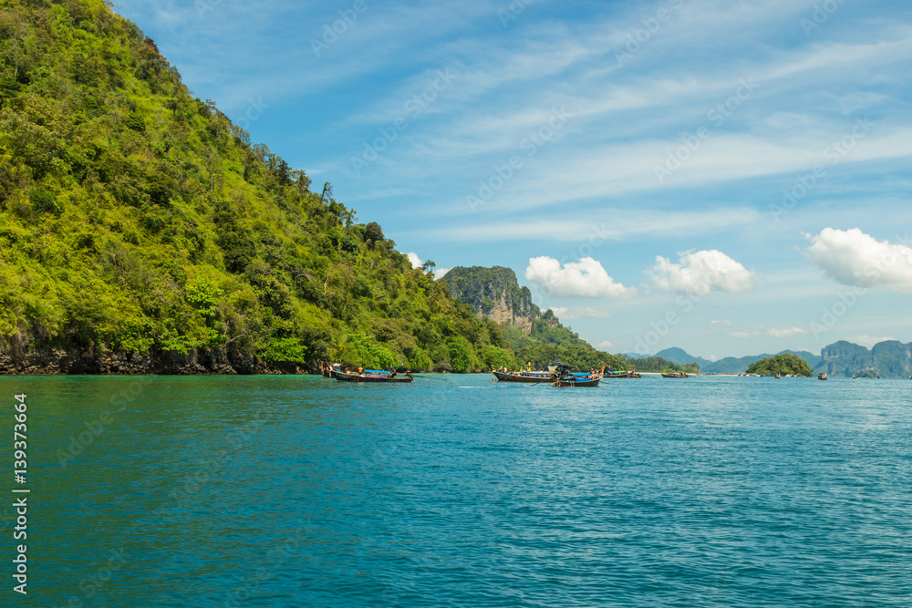 Tourist boats near Koh Poda Nok (Chicken island) in Andaman sea, Krabi province, Thailand