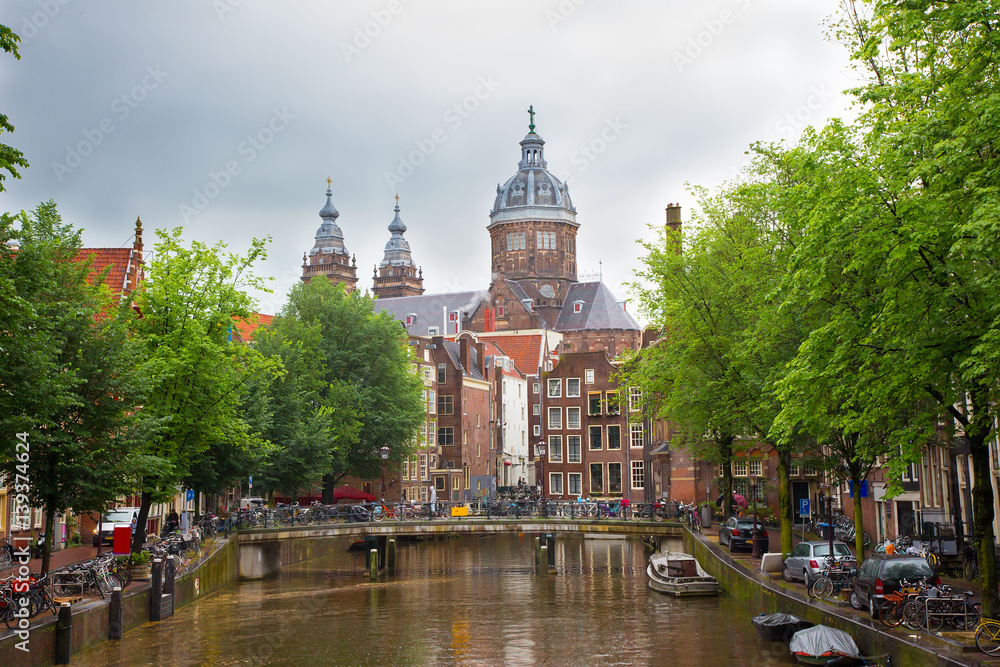 Beautiful cityscape of Amsterdam Canal and St. Nicolas Church