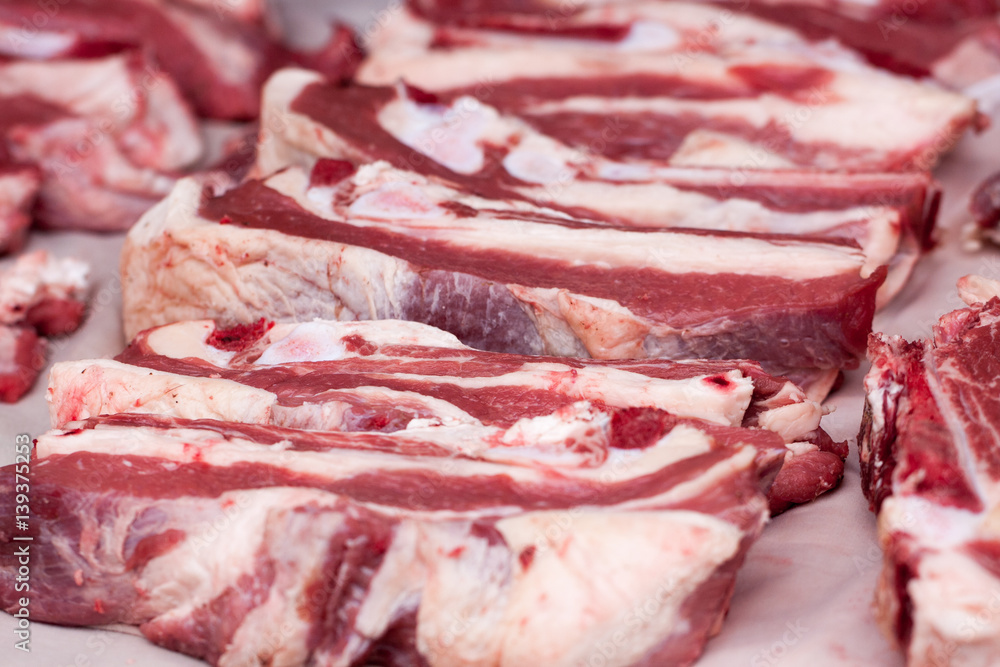 Fresh pieces of pork on the market counter. Selective focus Fresh pieces of pork on the market counter. Selective focus