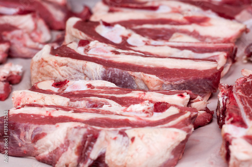 Fresh pieces of pork on the market counter. Selective focus