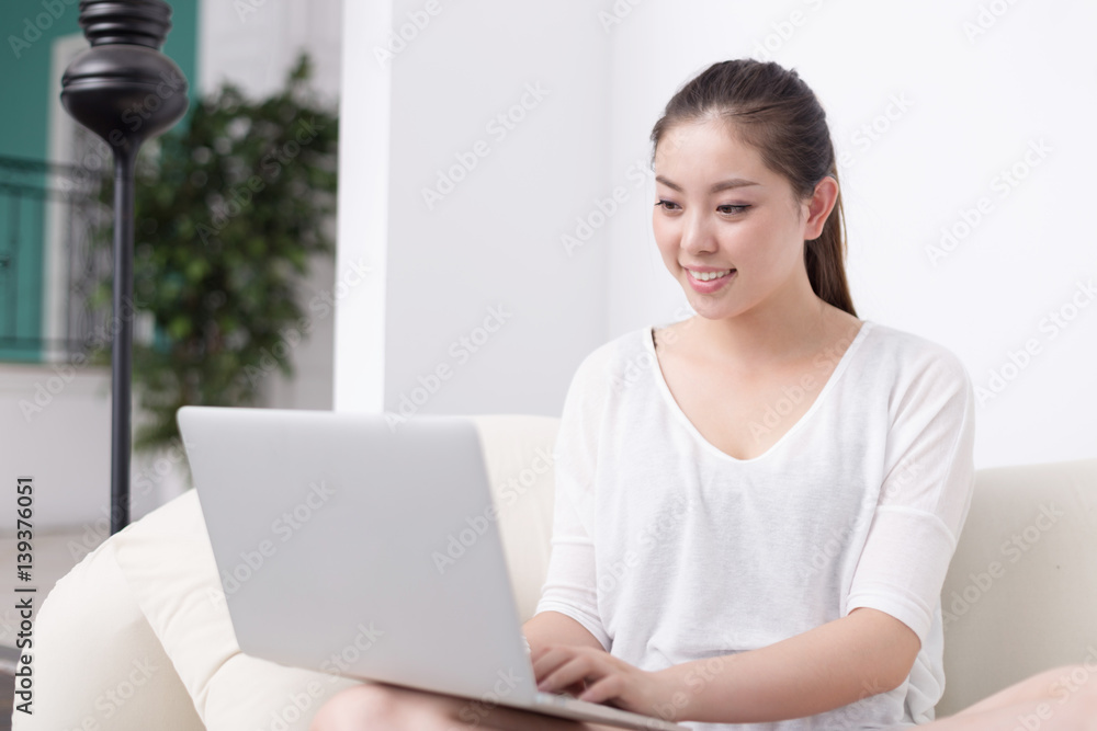 young pretty woman using laptop on sofa young pretty woman using laptop on sofa