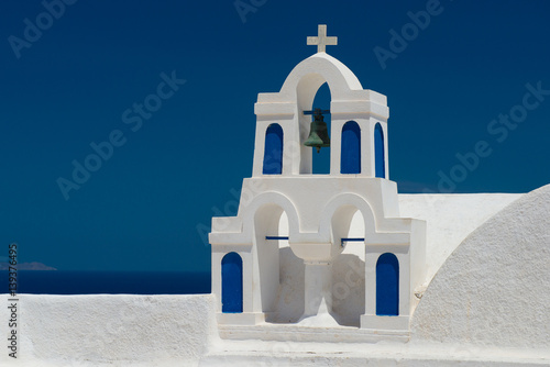 Architecture of island of Santorini, the most romantic island in the world, Greece. Travel to Greece. Beautiful white exterior Santorini. White church with bell tower