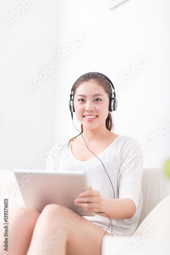 Wallpaper Mural young pretty woman relaxes with tablet Torontodigital.ca