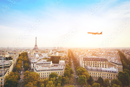 travel to France, airplane flying over beautiful panoramic cityscape of Paris with Eiffel Tower