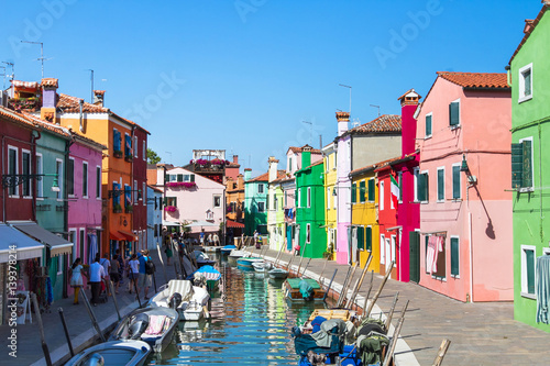 colorful street of Burano island, canal in Venice, multicolored houses in Italy © Song_about_summer