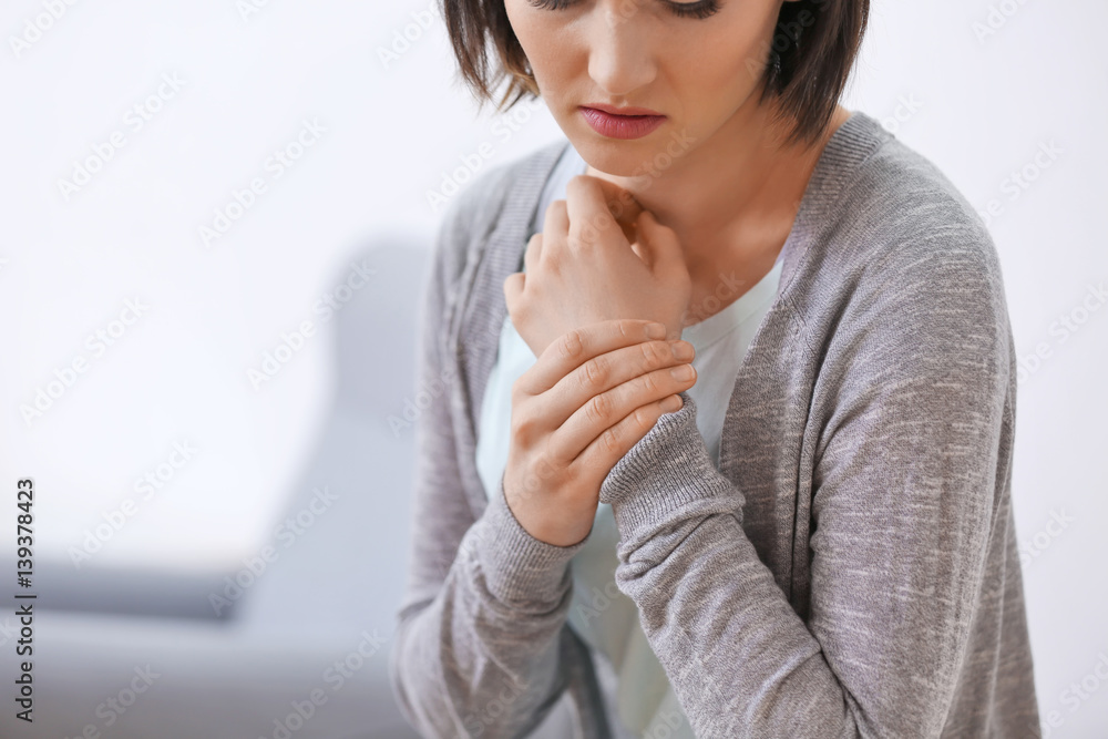 Young woman suffering from pain in wrist, close up Young woman suffering from pain in wrist, close up