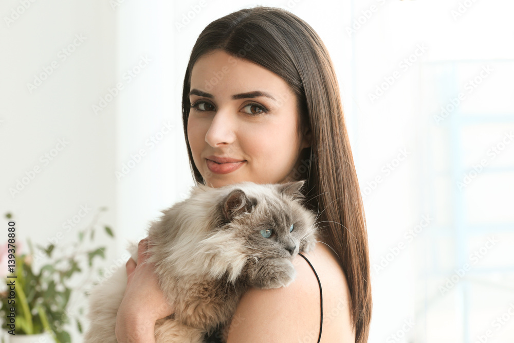 Beautiful young woman with cute cat resting at home Beautiful young woman with cute cat resting at home