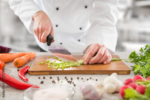 The chef slicing vegetables.
