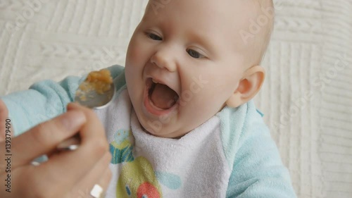 Baby happily tries first solid food