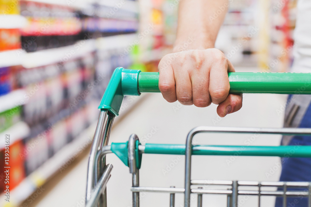 man in supermarket with the cart, food shopping