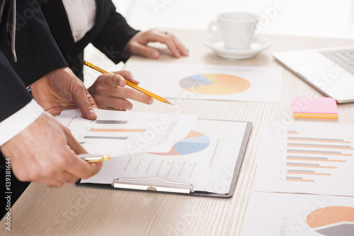 Business people working at meeting with charts photo