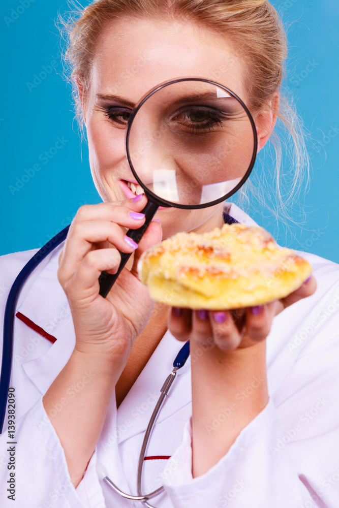 Doctor with magnifying glass examining sweet food Doctor with magnifying glass examining sweet food