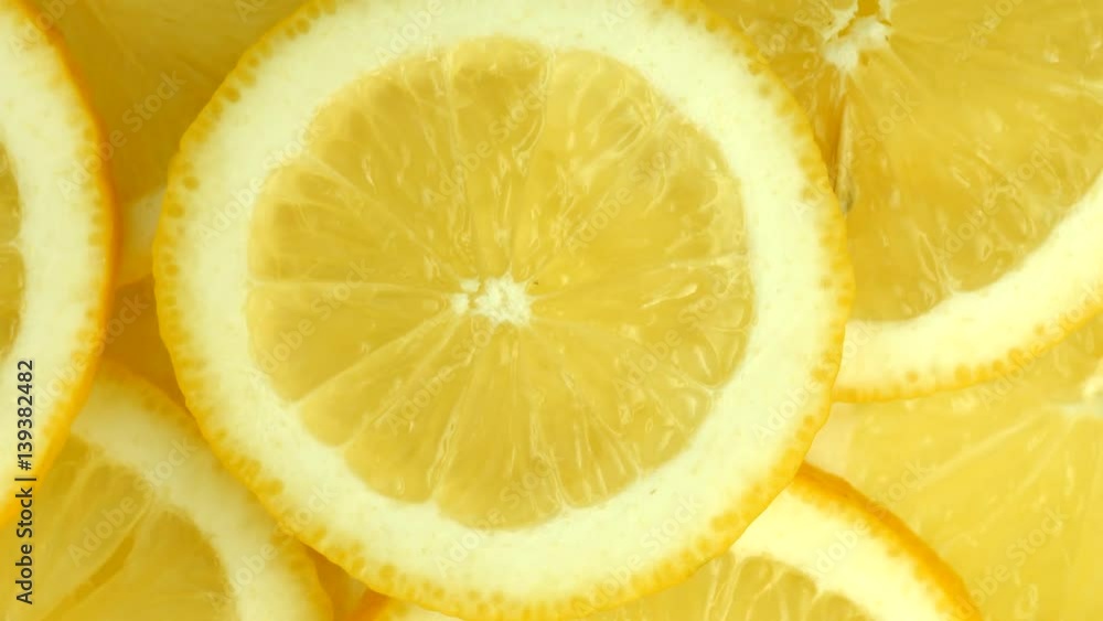 Lemon slices rotation background. Close-up of a delicious ripe lemon rotate Lemon slices rotation background. Close-up of a delicious ripe lemon rotate