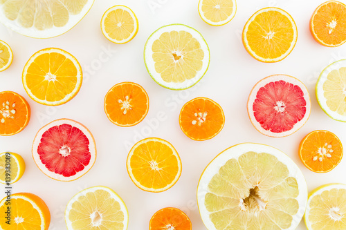 Citrus fruits pattern made of lemon, orange, grapefruit, sweetie and pomelo on white background. Flat lay, top view. Fruit's background