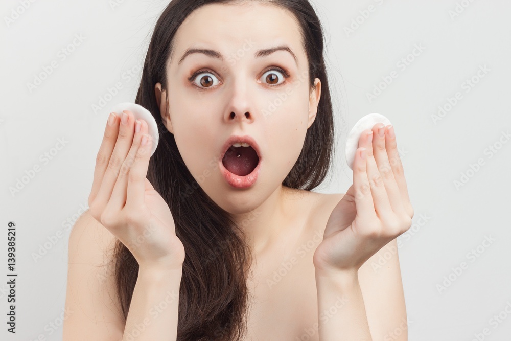 dumbfounded woman, two white cotton wool discs dumbfounded woman, two white cotton wool discs