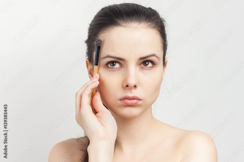 woman with makeup brush look up woman with makeup brush look up