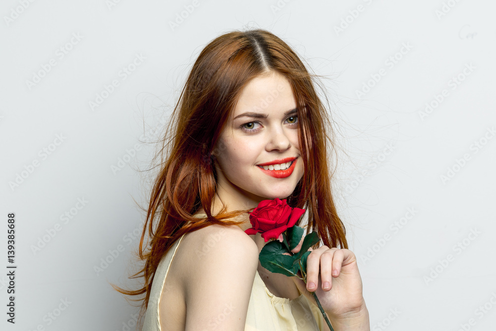 happy woman with a red rose on a light background happy woman with a red rose on a light background