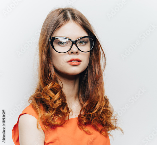 beautiful woman with glasses and an orange dress