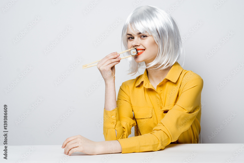 woman sit with rolls sushi 