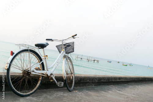 Bicycles parked on a bridge in the sea.