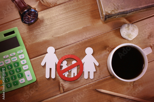 Calculator, coffecup, watch and family sign under prohibition sign - childfree concept photo