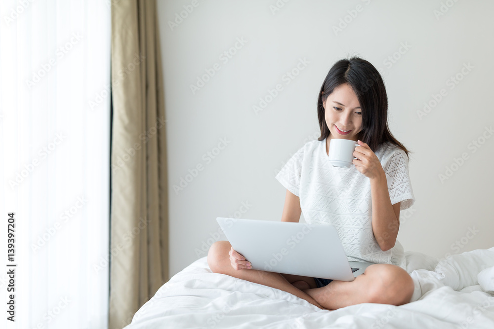 Woman drink of coffee and using laptop computer at home Woman drink of coffee and using laptop computer at home