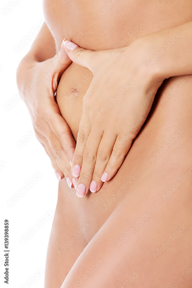 Attractive woman with hands on her belly.