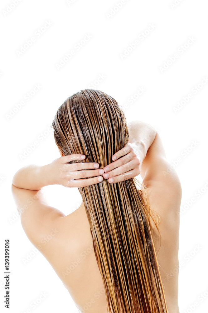 Naklejka premium Photo of woman applying hair conditioner.