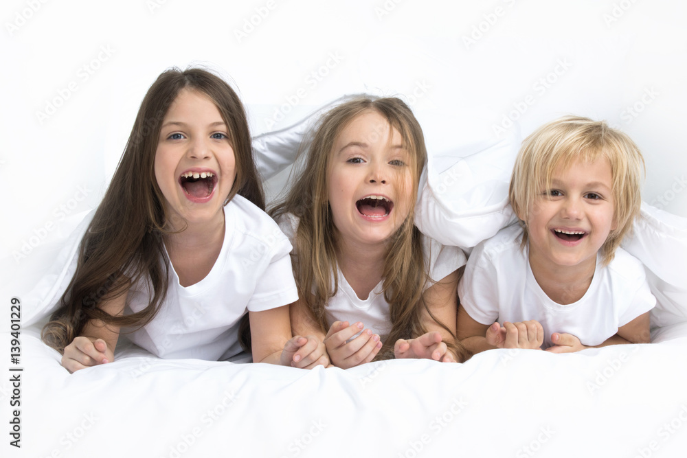 Three children waking up Three children waking up