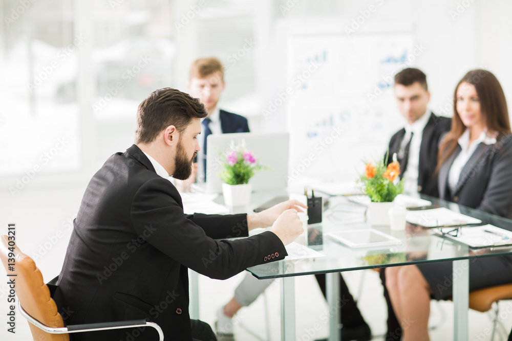 Manager and business team to discuss the presentation of a new financial project in a modern office Manager and business team to discuss the presentation of a new financial project in a modern office
