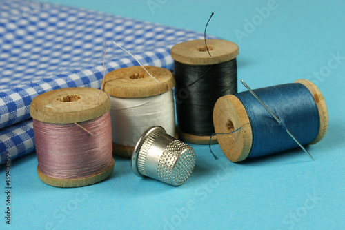 wooden spools with colored cotton threads for sewing, vintage
