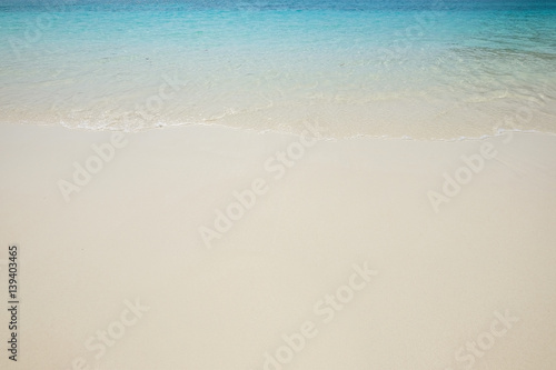 Blue sea wave on sand beach. Summer holiday relax background with copy space. © sirins