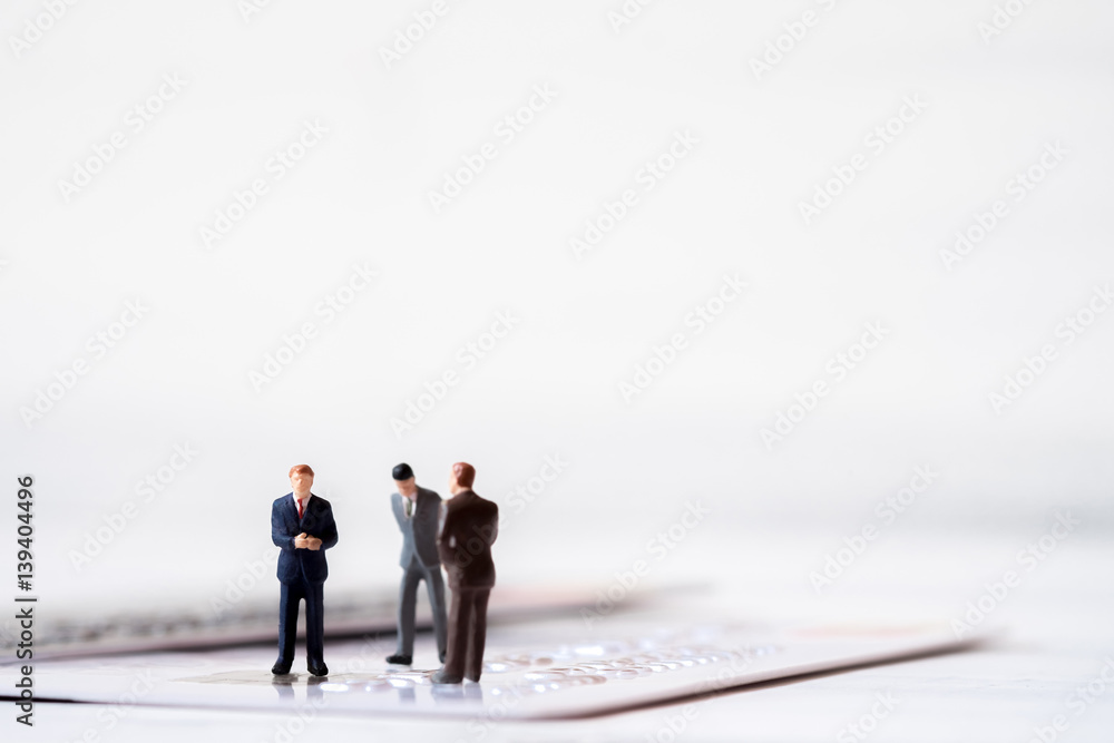 Miniature business people stand on credit card. Cash is king financial concept and more buy power. Miniature business people stand on credit card. Cash is king financial concept and more buy power.