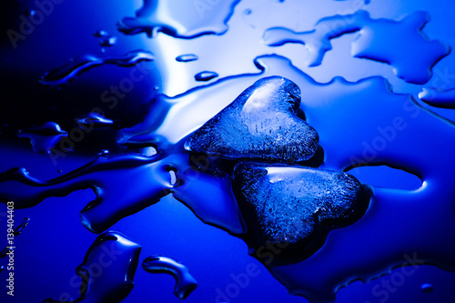 Two ice Hearts on blue